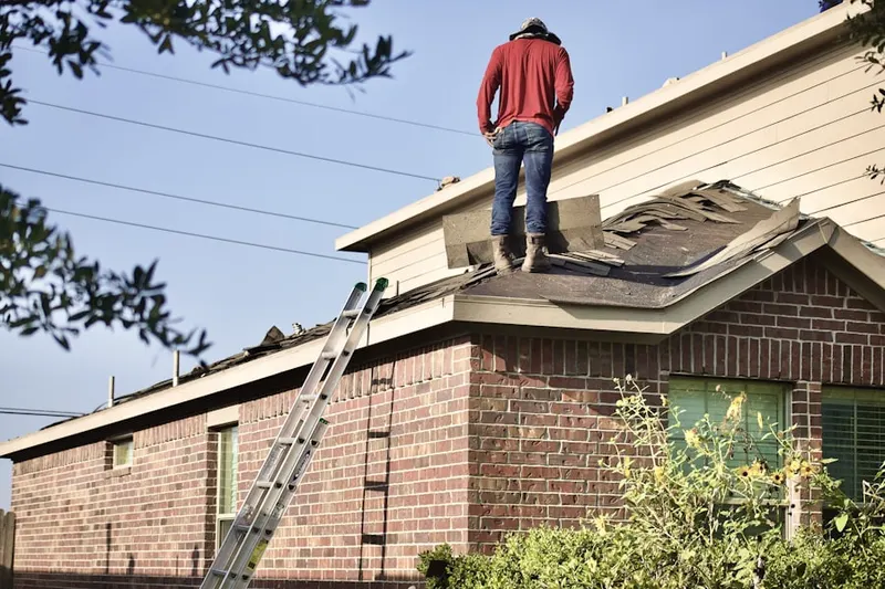 Professional roofer working on a residential roof in The Woods